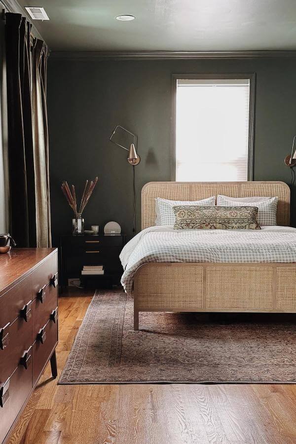 Natural rattan bed frame from @chelseabieberhome. Adds warmth and texture to an olive green bedroom.
