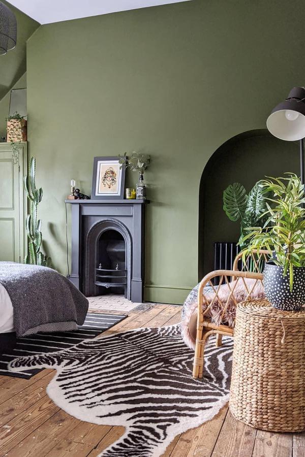 Bold zebra rug on moody olive walls from @ourneutralground. Perfect accent for olive green bedroom ideas.