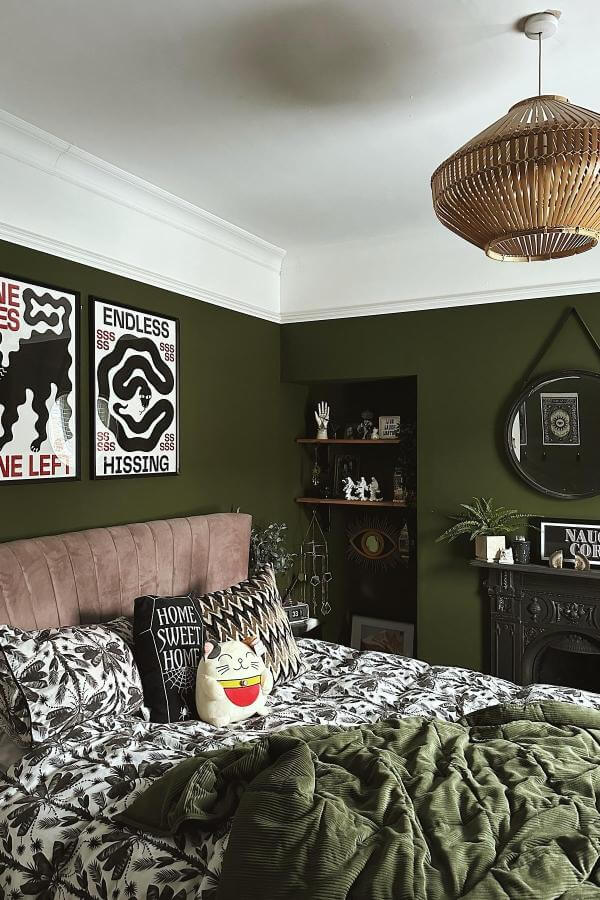 Eclectic art accents brighten olive green walls in a cozy bedroom setup from @ie.ame with unique decor pieces.