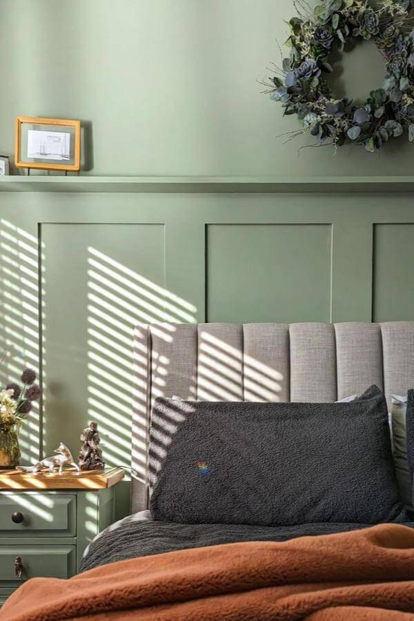 Bold olive green wall paneling and lush greenery in a bedroom from @lick. Adds depth to olive green bedroom decor.