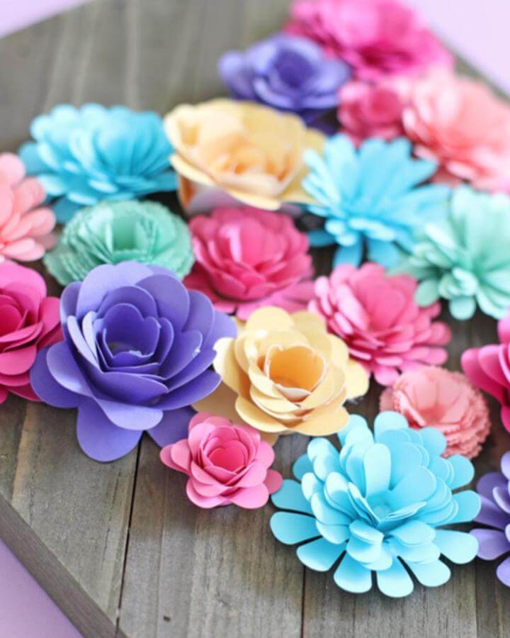 Colorful rolled paper flowers arranged on a wooden board by The Craft Patch paper crafts for adults vibrant handmade decor bouquet.