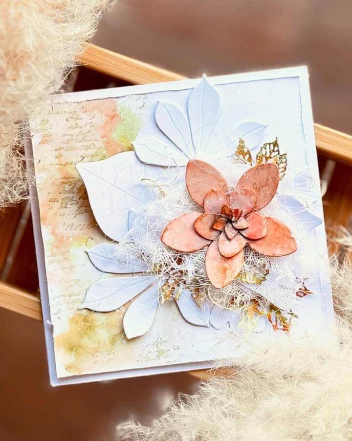 Soft peach flower with white and gold layered leaves on watercolor background by @li.l.a12. Paper crafts for adults with textured and delicate elements.