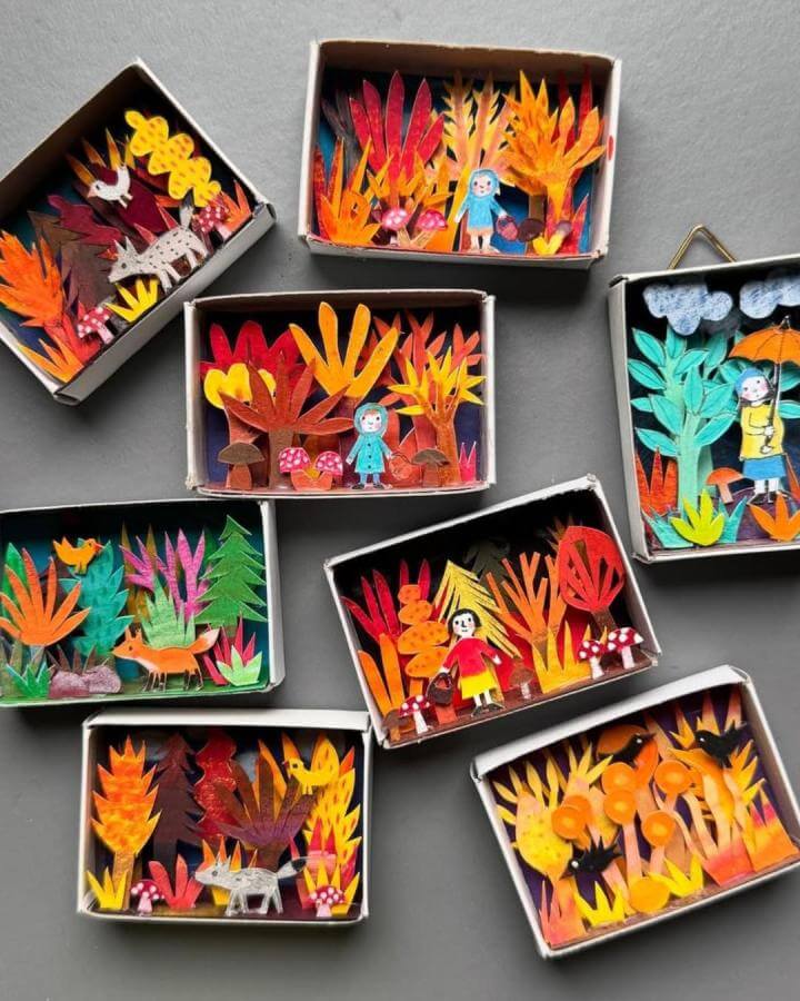 Orange and red paper matchbox dioramas by @antje.damm. Detailed tiny forest scenes with characters and mushrooms.