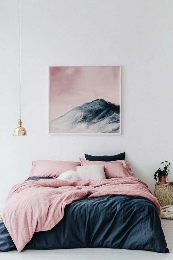 Pink and navy bedroom with elegant decor and cozy atmosphere.