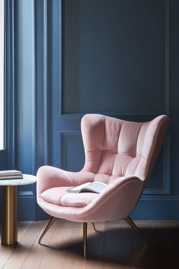 Pink and navy bedroom with patterned wallpaper and cozy bedding.