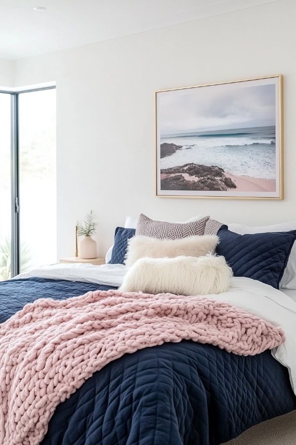 Pink and navy bedroom with cozy decor and elegant furnishings.