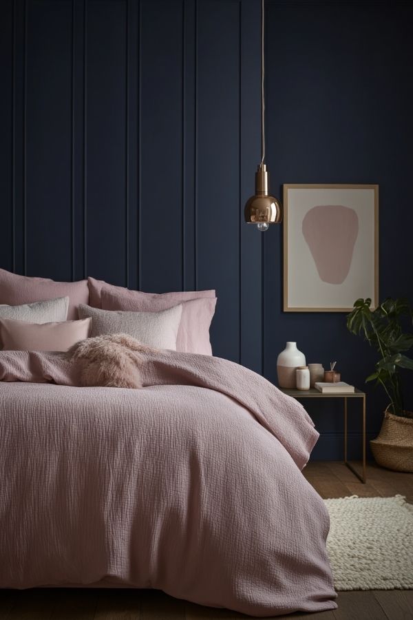 Pink and navy bedroom: elegant design with plush bedding and accents.