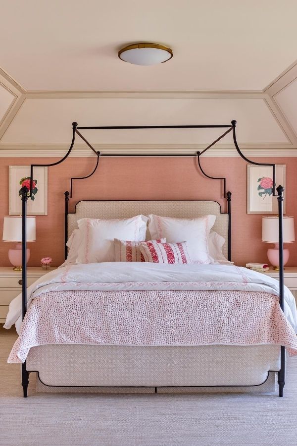 Elegant canopy bed draped in soft pink fabric creates serenity.