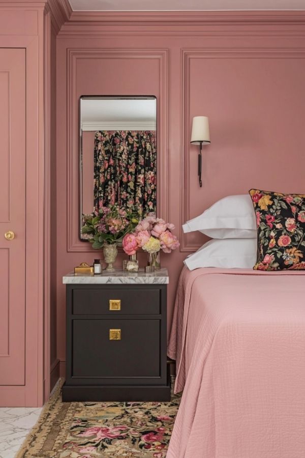 Elegant mauve bedroom with floral decor, cozy ambiance, and modern furnishings.