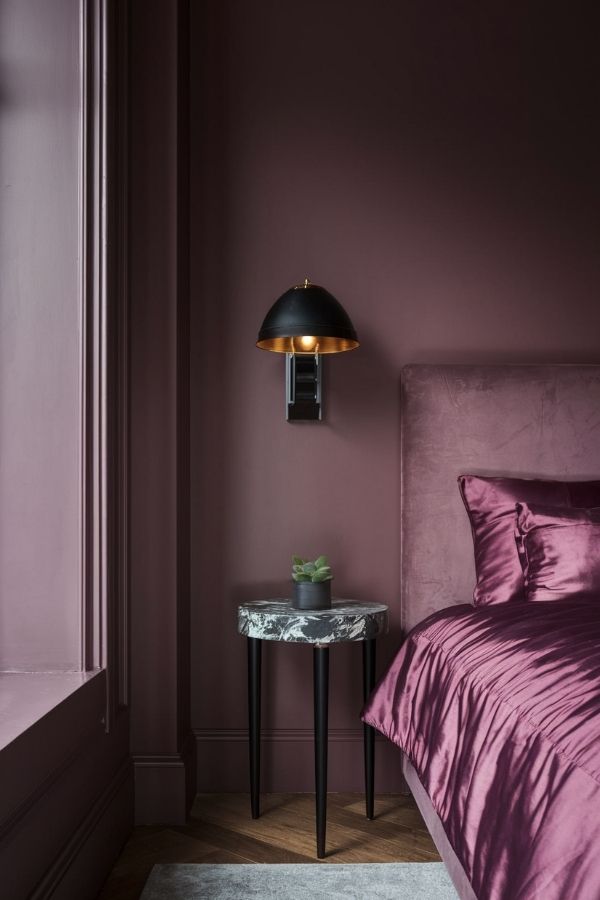 Elegant moody plum bedroom featuring luxurious textures and cozy ambiance.