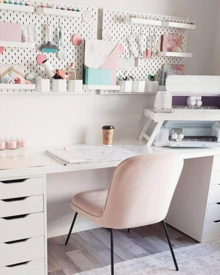 Soft pink velvet chair with white desk and pegboard organization, pink craft room ideas from @soyjefa.