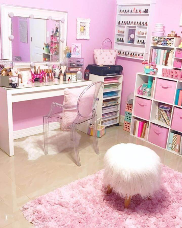 Pink and white fabric bins in a cozy craft space by @bobbincottage organize supplies against bubblegum pink walls with clear furniture accents.