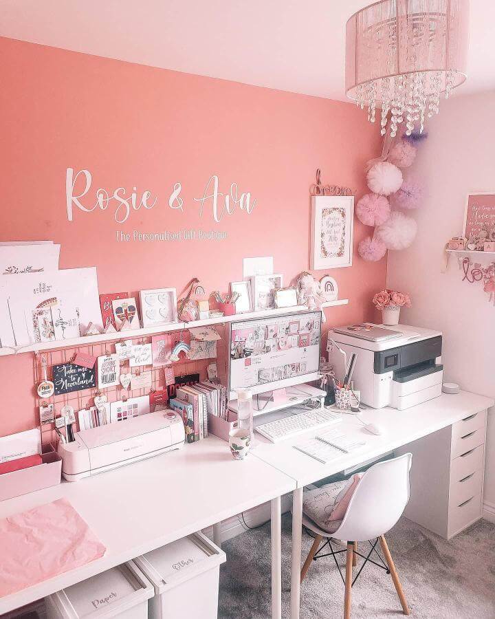 Coral accent wall craft room with white desk and pink decor from @kawaii.karla filled with creative and organized workspace details