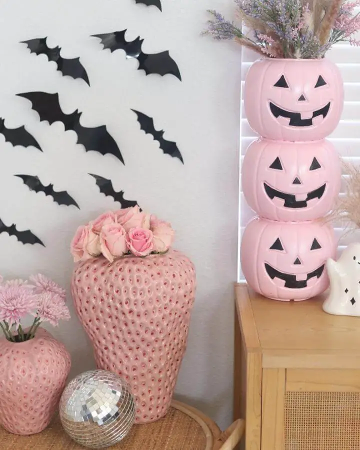 Stacked pink jack-o'-lantern tower from @safiinmotherland showcasing creative pink halloween decor ideas with roses and bat wall decals.