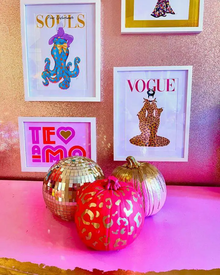 Glamorous metallic and leopard print pumpkins from @theelectricpenguin. Positioned beneath colorful Halloween themed gallery wall art.