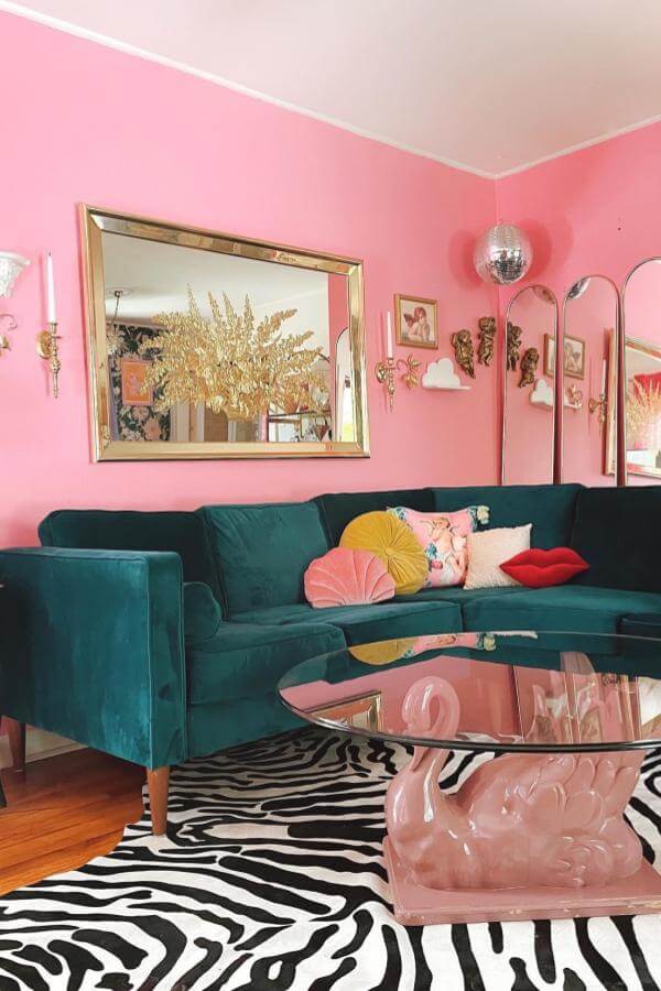 Disco ball charm enhances pink living room ideas with vibrant walls.