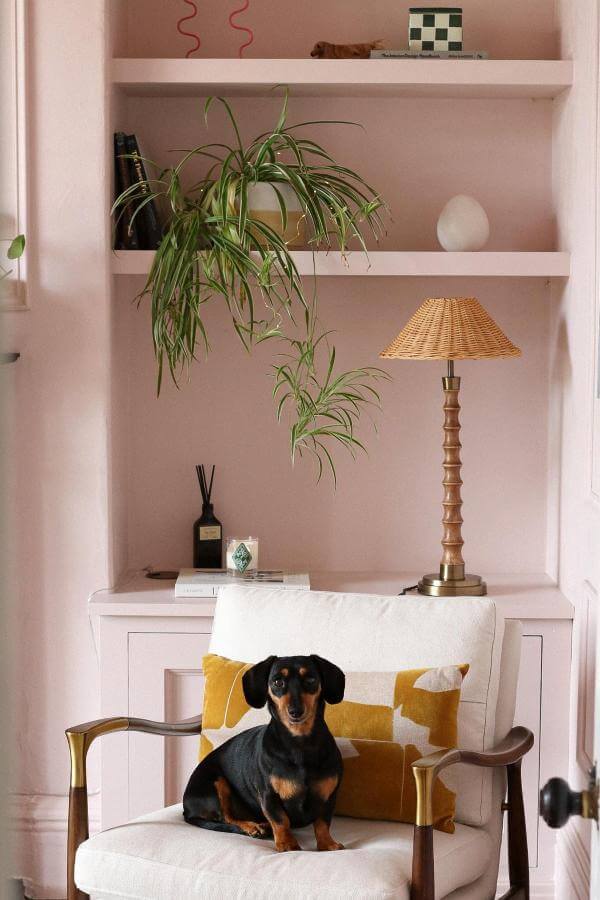 Quirky elegance with mustard accents enhances pink living room ideas.