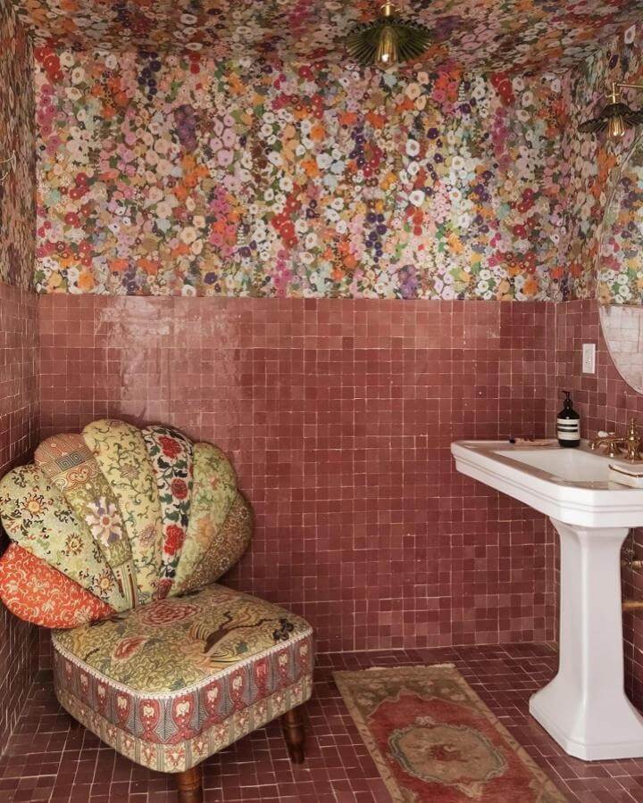 pink floral wallpaper and dusty rose tile pink powder room ideas from @reno_notebook with vintage patterned chair and brass accents