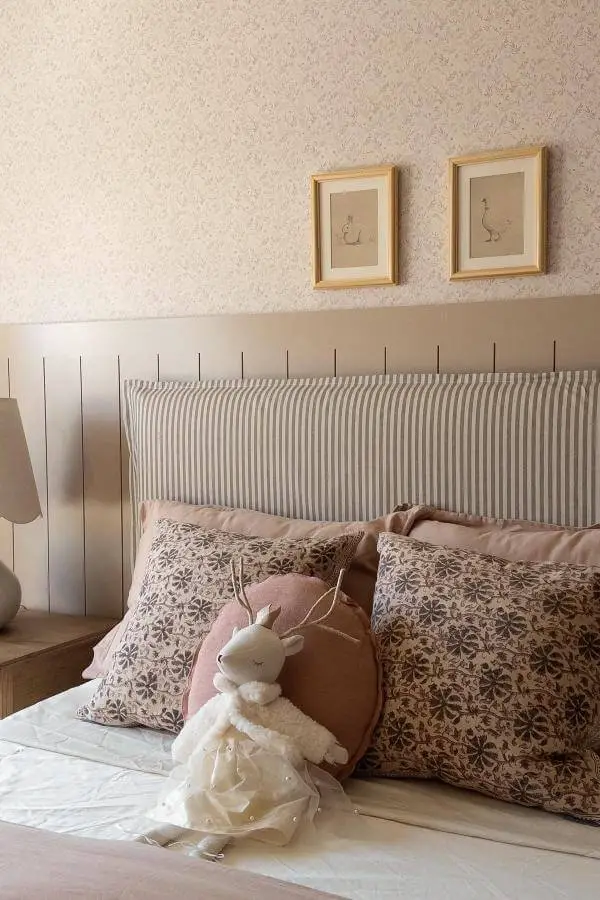 Soft pastel pillows and whimsical plush accents in a cozy bedroom vignette from @accordingtomandy.