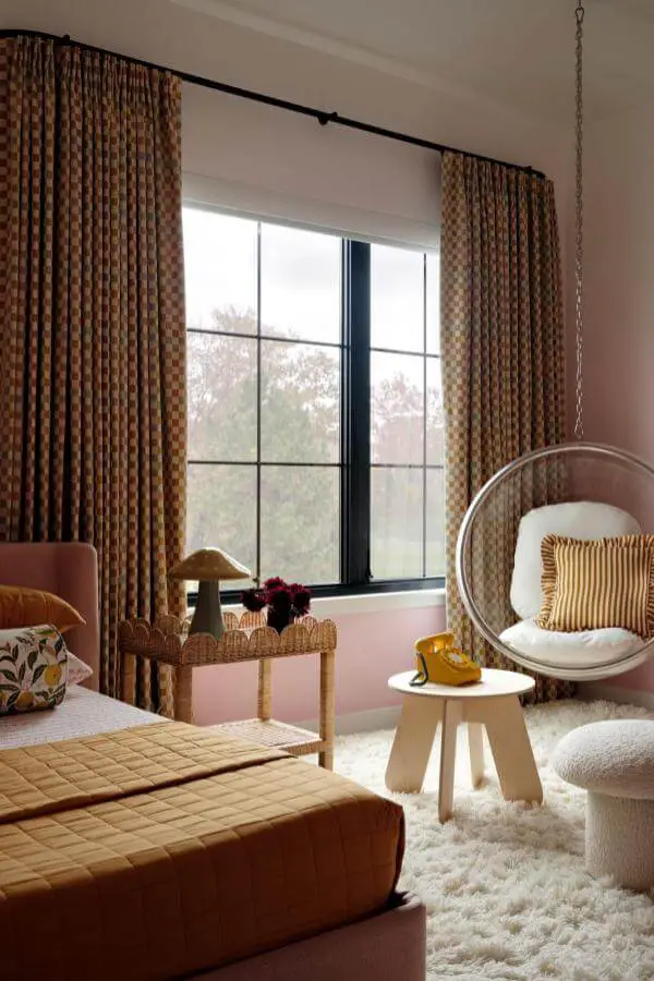 Chic woven hanging chair creates playful hangout corner in pink teenage girl bedroom from @jaquiseerman. Cozy and stylish.