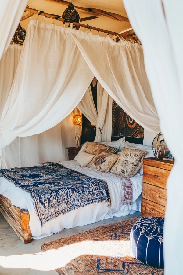 Playful chic boho bedroom with colorful textiles, eclectic decor, and plants.