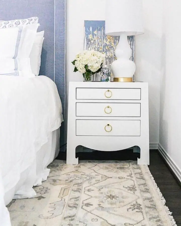 Classic white nightstand from @merrittbeck. Features gold ring pulls and curved bottom detail.