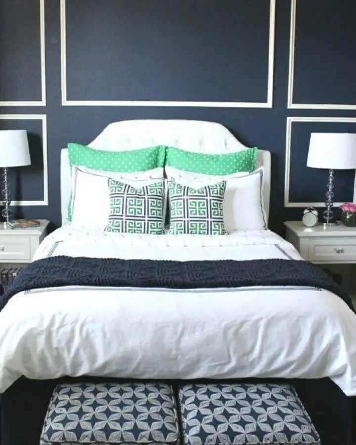 Navy blue accent wall with white trim molding from @dwellinggawker. Features geometric rectangles and classic color scheme.