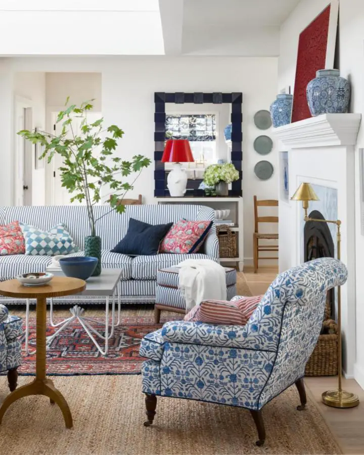 Classic blue and white patterned furniture from @traditionalhome featuring striped sofa and floral armchair.