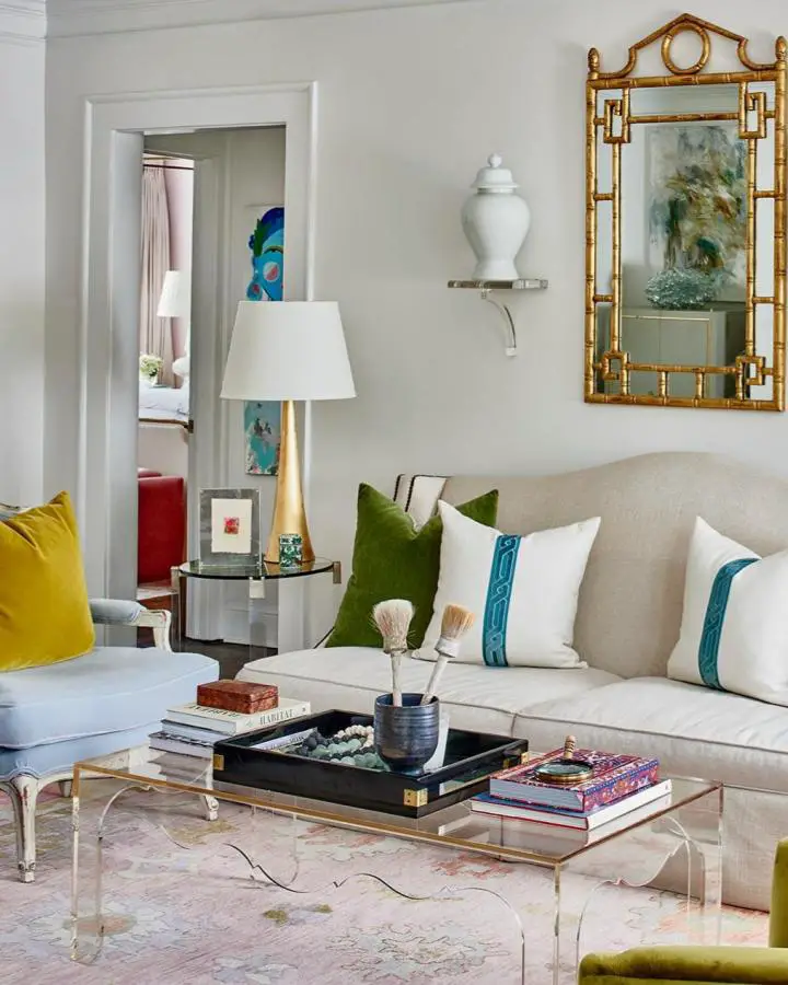 Golden bamboo mirror with geometric details from @courtneymossdesign. Neutral gray walls showcase the sophisticated metallic frame beautifully.