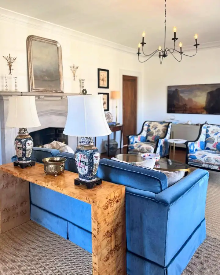 Blue upholstered furniture with chinoiserie lamps from @courtneymossdesign showcasing timeless preppy living room ideas and traditional styling.