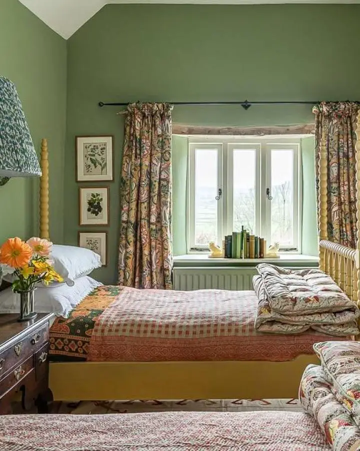 Sage green bedroom from @elizabethhaydesign showcasing botanical pretty bedroom ideas with floral curtains and natural lighting.