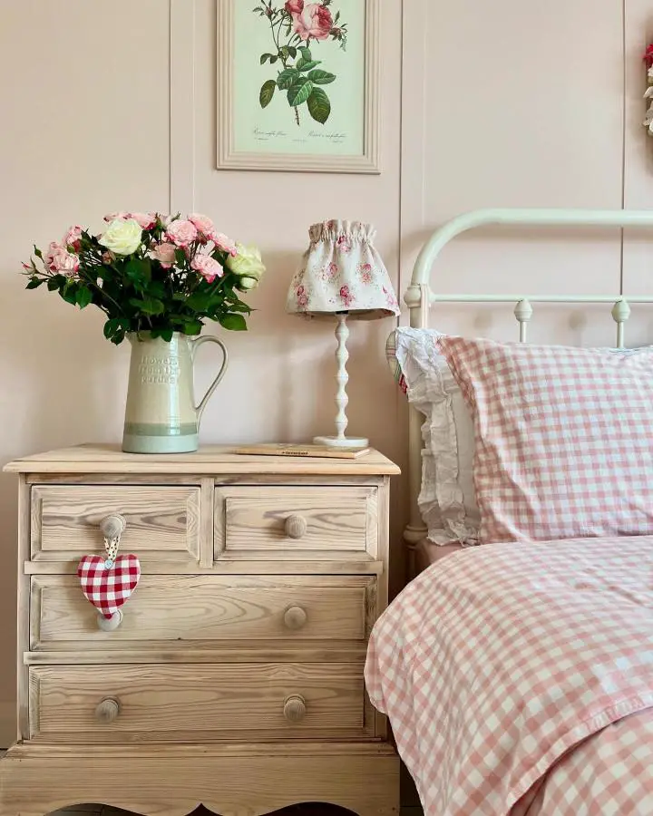 Pink gingham bedding and natural wood furniture from @haresandhome showcasing cozy pretty bedroom ideas