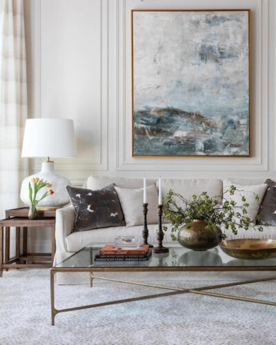 Blue and gray abstract artwork from @lizmearns showcasing pretty living room ideas with neutral sofa styling