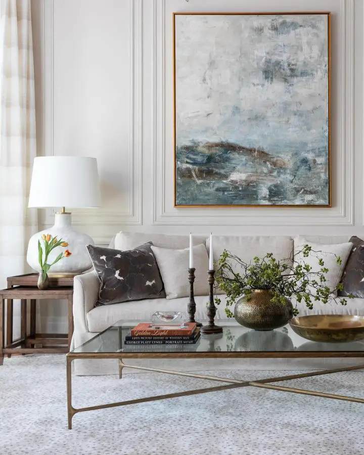 Blue and gray abstract artwork from @lizmearns showcasing pretty living room ideas with neutral sofa styling