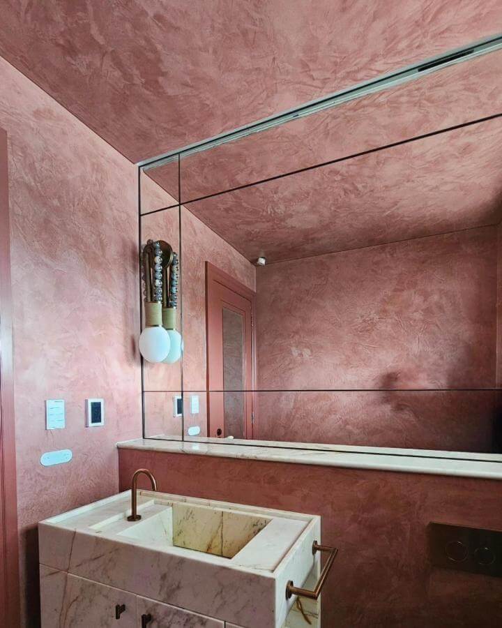 Red textured walls and ceiling with marble sink in a red powder room from @creativetexturesau showcasing luxurious red powder room ideas.