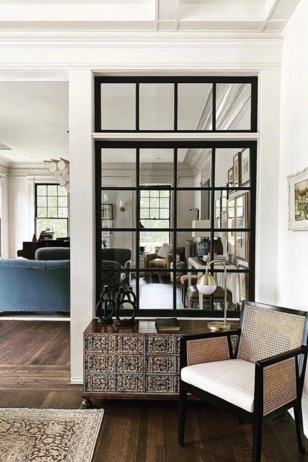 Elegant black-framed glass panels enhance space with stylish room divider ideas.