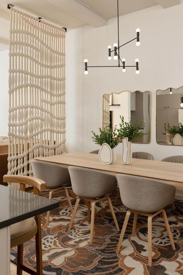 Macramé room divider elegantly defines open dining space, inspiring room divider ideas.