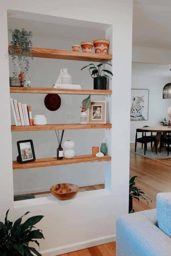 Floating shelves showcase a natural charm, perfect for room divider ideas.