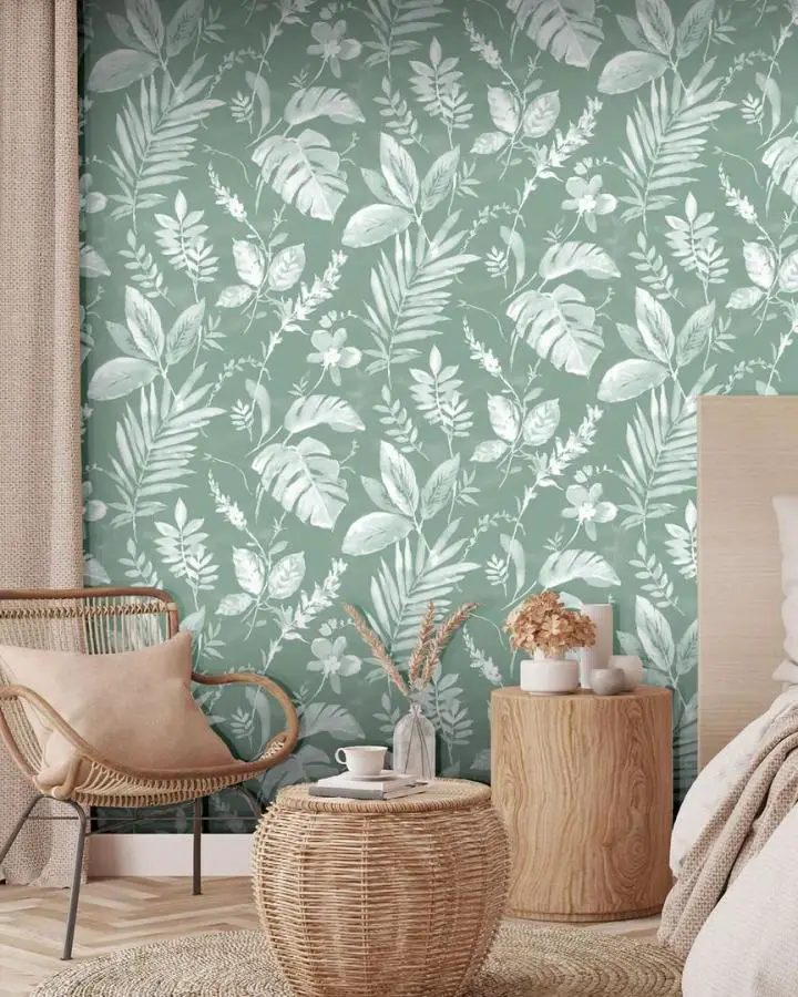 Botanical sage green wallpaper bedroom from @worldofwallpaperuk showcasing white leaf patterns perfect for sage green bedroom ideas with natural rattan furniture.