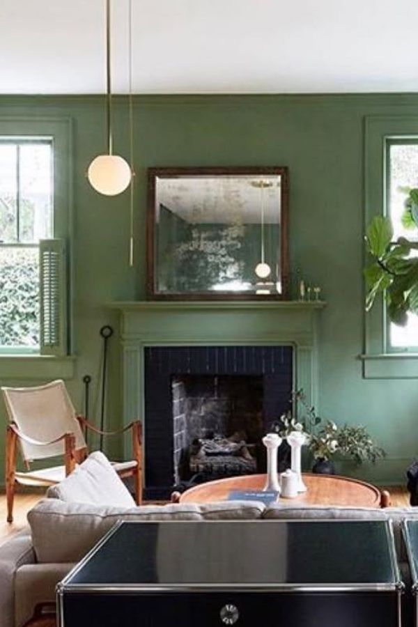 Sage green living room ideas: elegant room, stylish mirror, soothing atmosphere.