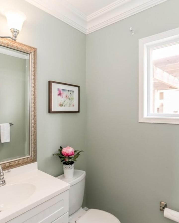 Sage green powder room ideas with white vanity and floral decor from @debicollinsondesigns. Soft, fresh, elegant space.