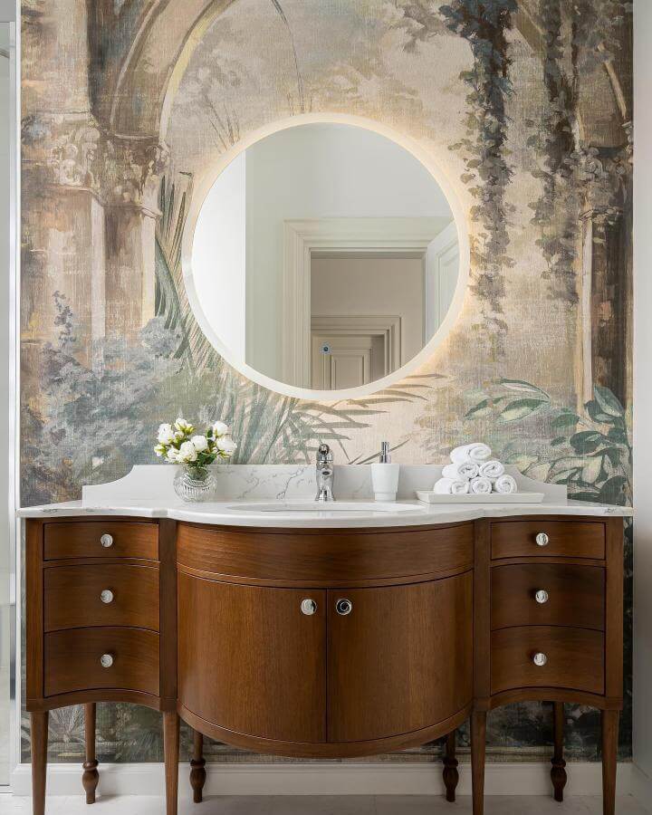 Warm wooden vanity with marble top in a sage green powder room ideas setting by @mihai.georgiadi. Classic mural background with natural elements.