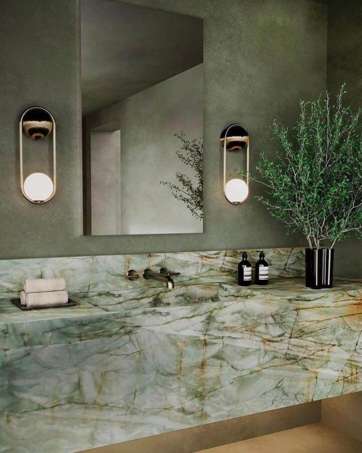 Sage green powder room ideas with marble stone vanity, brushed brass fixtures, and minimalist lighting from @nancyosbornere featuring natural greenery.