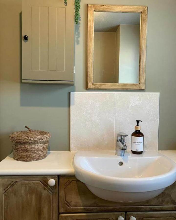 sage green powder room ideas with rustic wood cabinetry and soft sage walls from @nicsyorkshirehome simple, calming, and practical space design