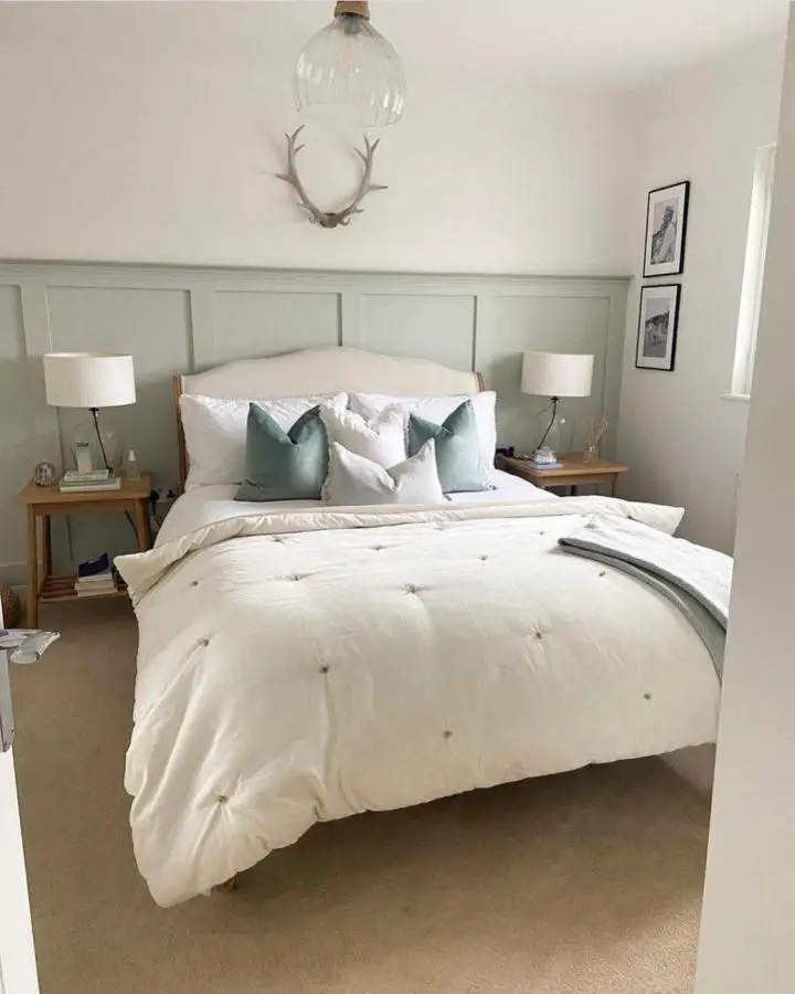 Serene bedroom from @oursomersetnest featuring sage green paneling, white bedding, and natural wood accents.