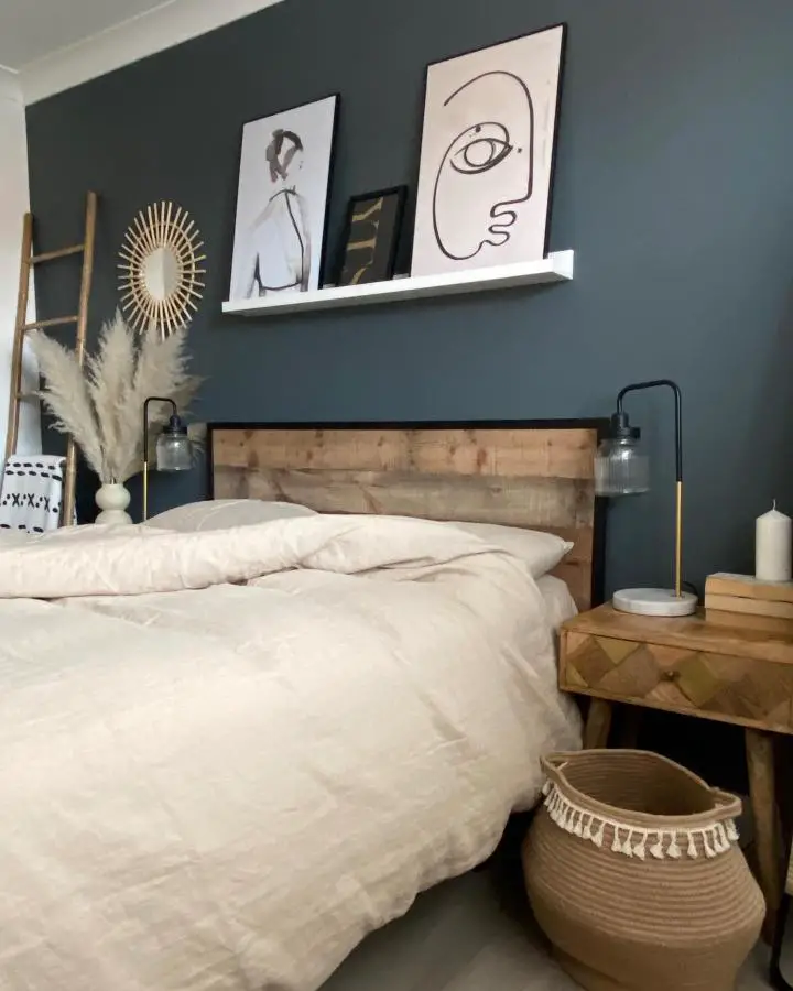 Teal accent wall bedroom from @my_neutral_place with natural wood headboard and neutral bedding.