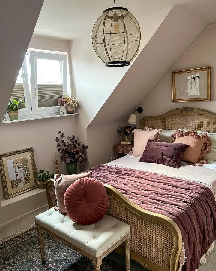 Cozy attic bedroom from @retwiggdstylist showcasing small bedroom ideas with slanted ceilings and burgundy bedding.