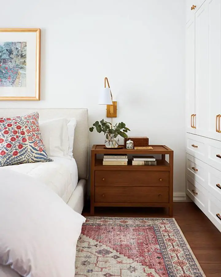 Walnut nightstand with built-in storage from @chrisstewart.rmx. Features open shelving and drawers for compact living.