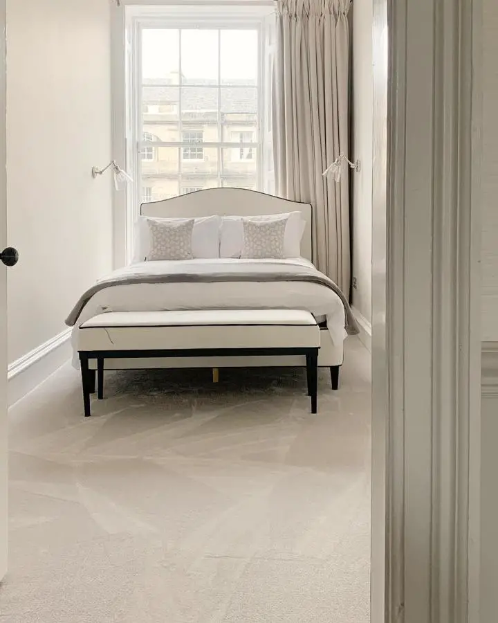 Neutral beige bedroom from @sticksandthecity_ showcasing clever small bedroom ideas with coordinated curtains and bedding.