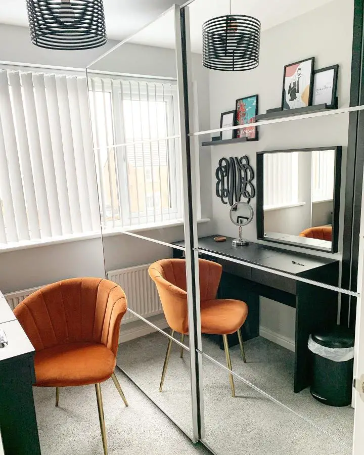 Modern dressing area with large floor mirror and orange velvet chairs from @made_at_no.29. Built-in desk maximizes compact space.